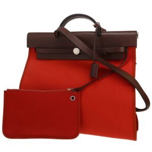 Hermès Herbag bag worn on the shoulder or carried in the hand in orange canvas and brown leather