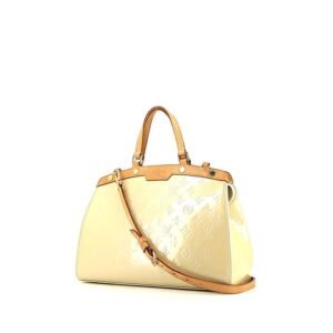Louis Vuitton Brea handbag in cream color patent leather and natural leather